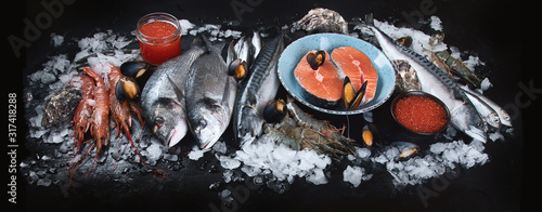 Photography Fresh fish and seafood on black background.