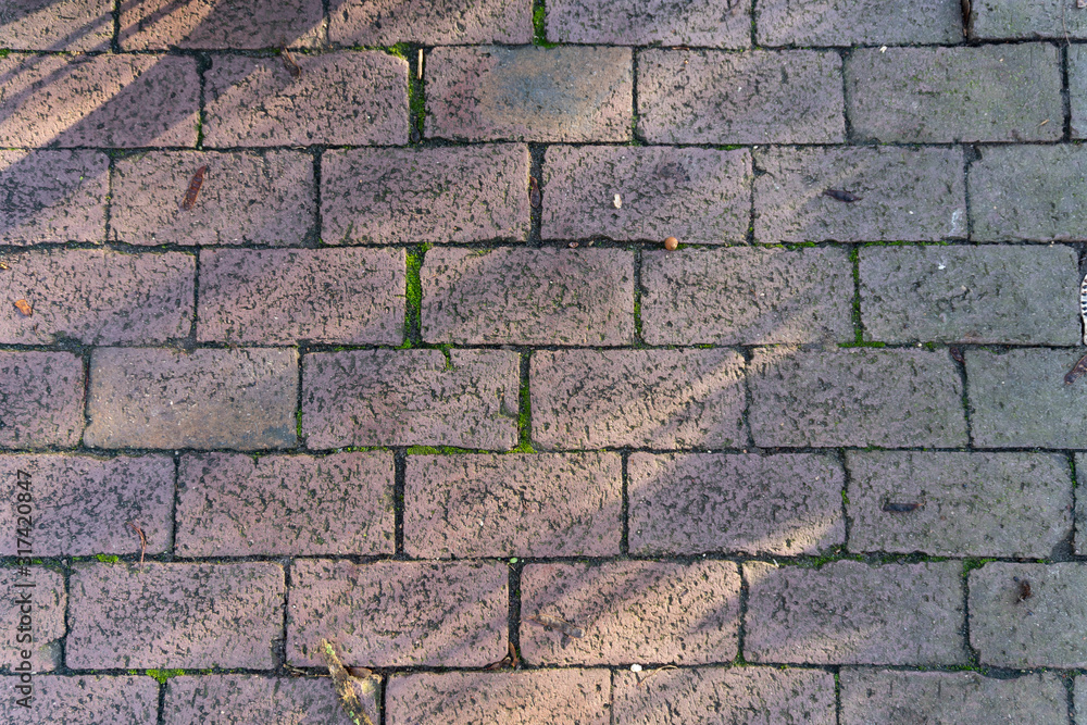Close up of cobblestones with light and shadow - top view Close up of cobblestones with light and shadow - top view