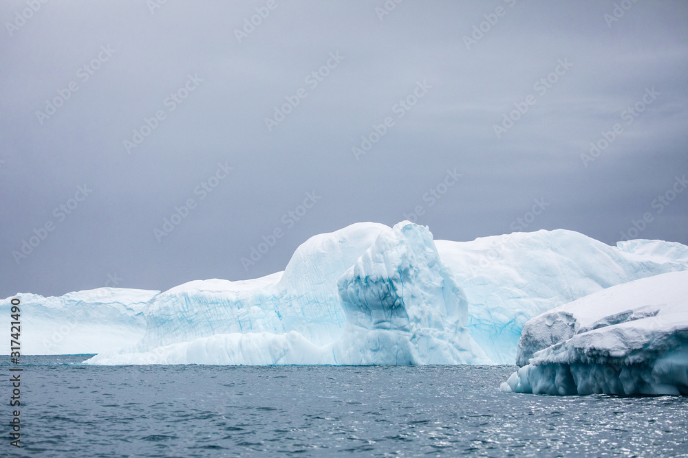 Large icebergs floating in the cold water of Antarctica