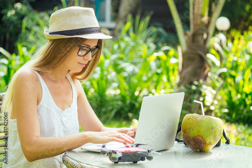 Photography photographer blonde female working outdoor retoucher and drinking coconut