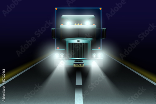 The truck with headlights on night road.