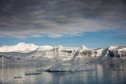 Snow and ice on the mountains near the water in Antarctica, a pristine remote landscape © Gabi
