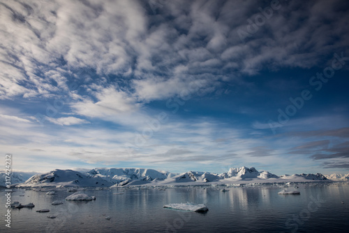 Snow and ice on the mountains near the water in Antarctica, a pristine remote landscape