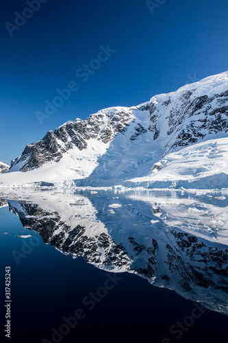 Snow and ice on the mountains near the water in Antarctica  a pristine remote landscape