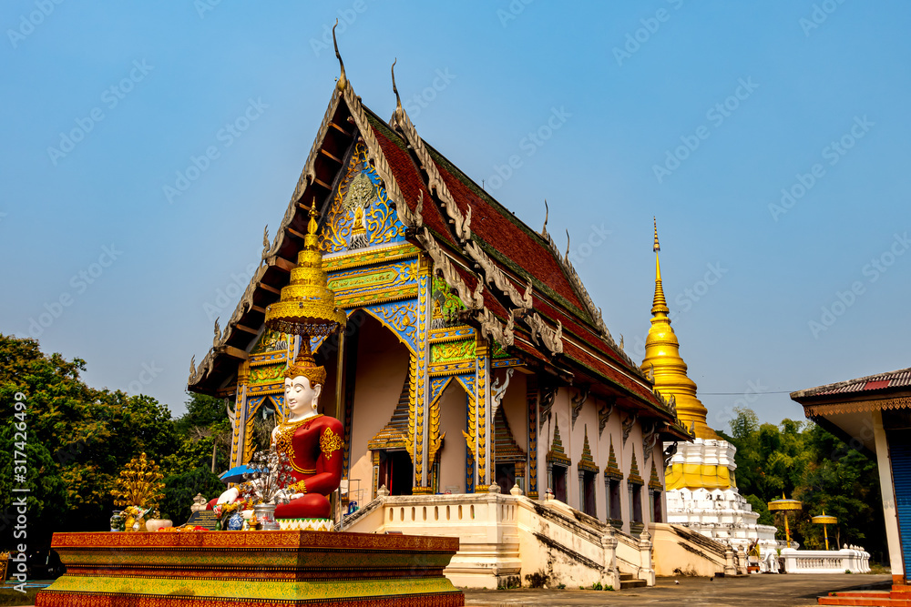 Wat Khu Kum, the ancient buddhist temple with the big Seated Buddha, the new main hall that build in April 27. 1972 /2515 and the Pagoda in Muang District, Lampang Province, Thailand.