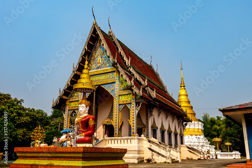 Wallpaper Mural Wat Khu Kum, the ancient buddhist temple with the big Seated Buddha, the new main hall that build in April 27. 1972 /2515 and the Pagoda in Muang District, Lampang Province, Thailand. Torontodigital.ca