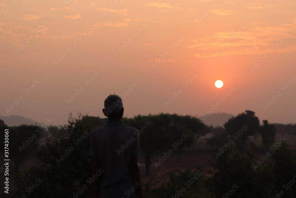 indian farmer in traditional clothes in Autumn mountains at sunrise in India indian farmer in traditional clothes in Autumn mountains at sunrise in India