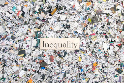 Newspaper confetti from above with the word Inequality photo