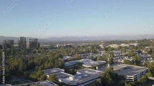 Aerial Drone View 4K Tilting Shot of Woodland Hills Thousand Oaks California Stunning Sunset Mountain View of Entire Valley with Gorgeous Green Trees & Scenery with Buildings Nearby 
