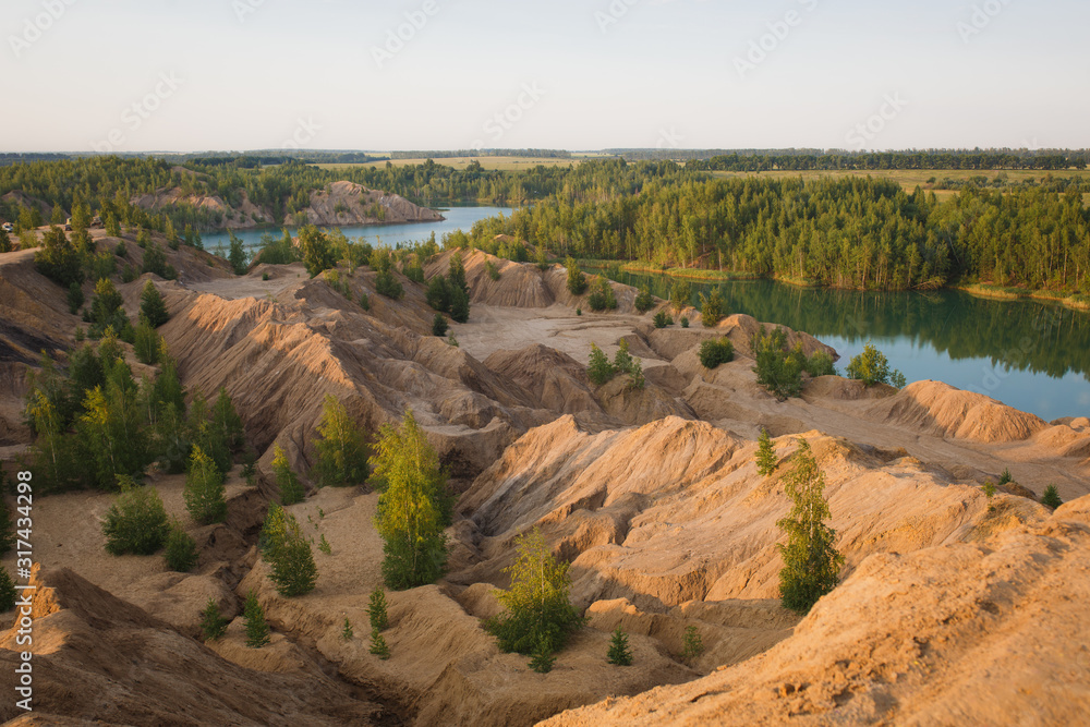 Blue lake in the mountains in summer at dawn. Lake in the village of Konduki in the Tula region on abandoned sand pits.