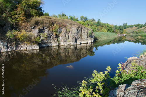 Stone cliff on the river bank © eladstudio