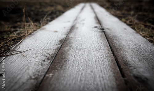 Hoarfrost on a wooden board as a background