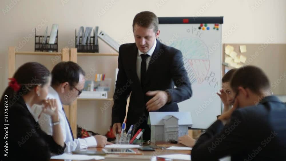 The boss swears loudly at his subordinates, grabs a stack of papers