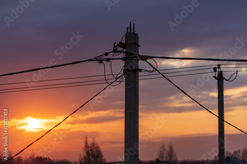 Electric post at dawn of the sun