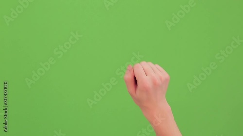 Hand knocking on the green screen. Single handed gesture. Chromakey. Isolated. Real time video footage.