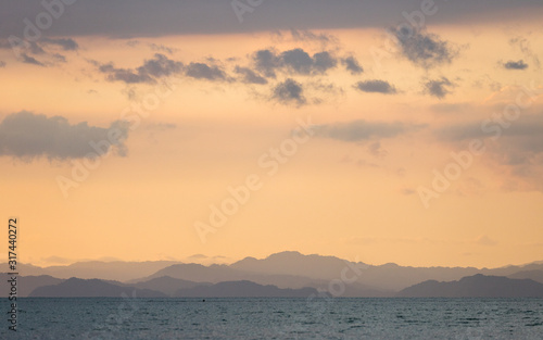 Sunset on the beaches of the Pacific Ocean in Costa Rica overlooking the Nicoya Peninsula  birds and fishermen.