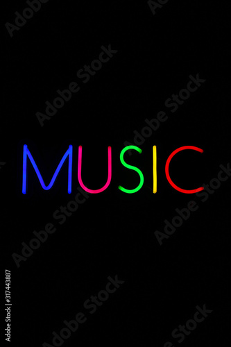 Multicolored music sign on isolated black background. Neon concept. Modern style. Neon sign. Flat lay, copy space, top view. 