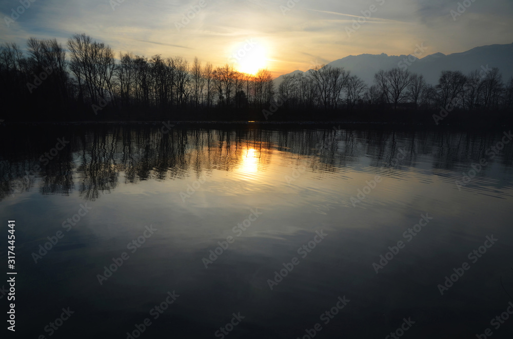 Sunset over an Alpine Lake with Mirror Image and Mountain in Switzerland. Sunset over an Alpine Lake with Mirror Image and Mountain in Switzerland.