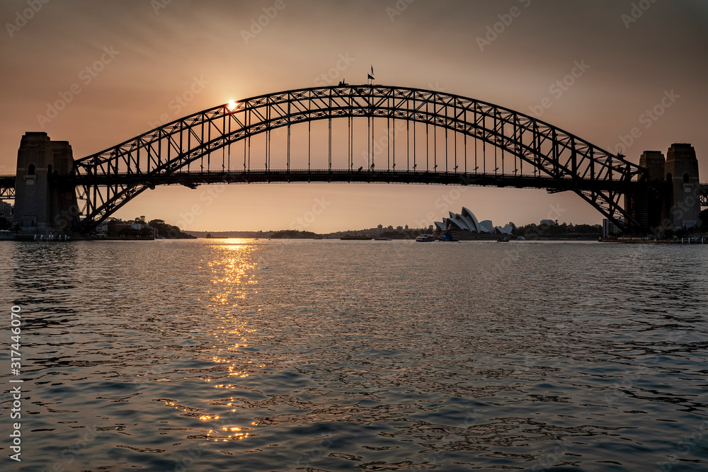 Sydney Harbour Bridge seen across the water at sunset