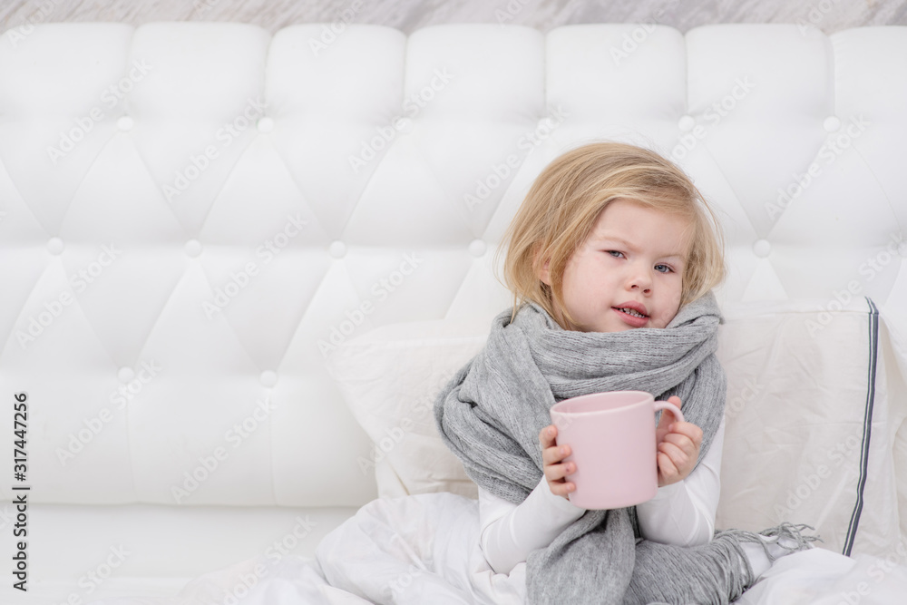 little sick girl drinking from a mug