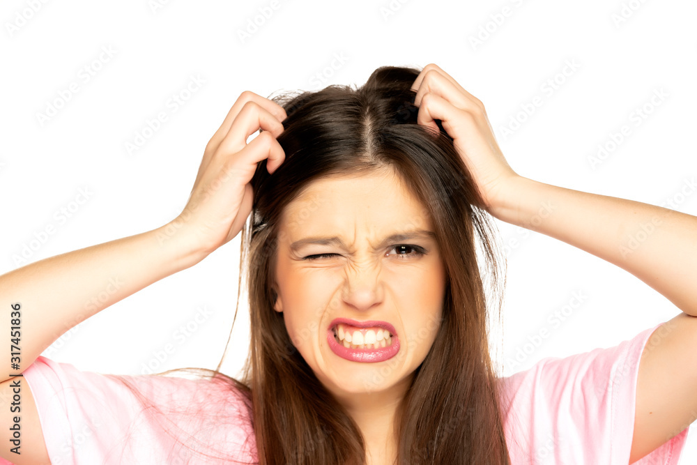 portrait of young nervous woman scratches her head portrait of young nervous woman scratches her head