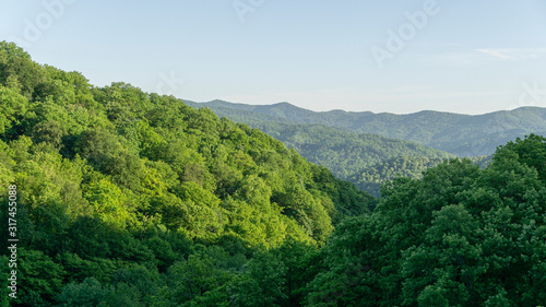 Picturesque mountain landscape with green forest peaks of Caucasus Mountains. Spring landscape at the pass in Goryachiy Klyuch. Krasnodar region, Russia photo