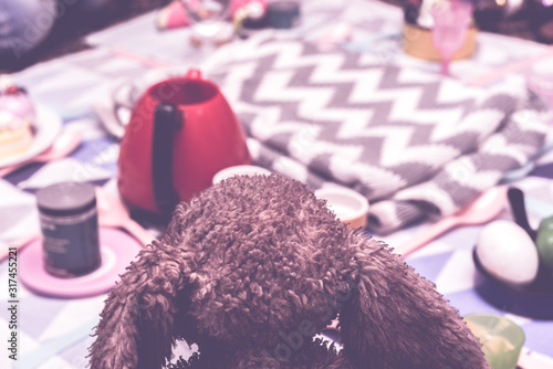 Fotografie kids play make believe tea party with children's toys and tea set in bedroom