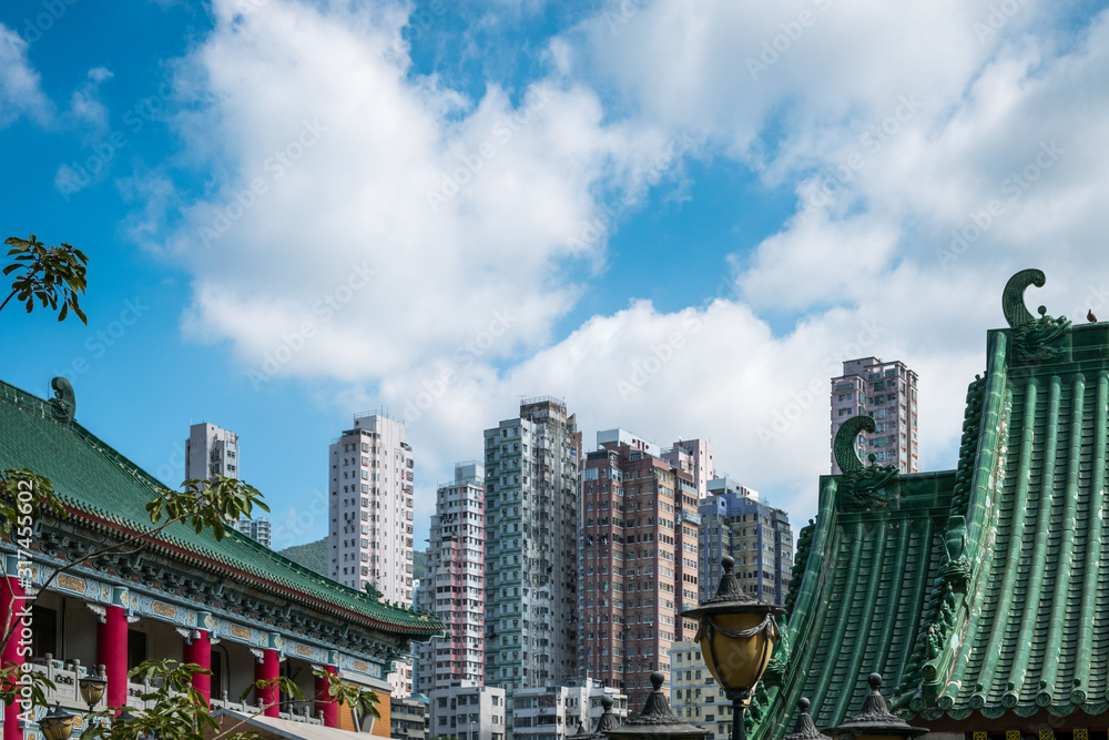Traditional, classic Chinese temple roof and modern skyscraper architecture in HongKong -