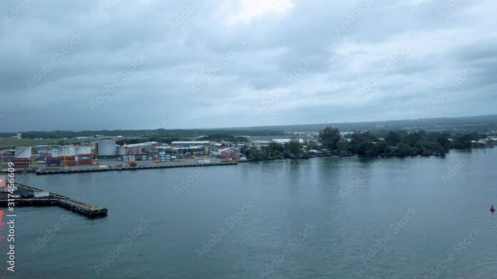 Cityscape from cruise ship in Hilo on the Big Island of Hawaii. On the east side of the Big Island of Hawaii, is a crescent-shaped bay along which the small town of Hilo is nestled. Cityscape from cruise ship in Hilo on the Big Island of Hawaii. On the east side of the Big Island of Hawaii, is a crescent-shaped bay along which the small town of Hilo is nestled.