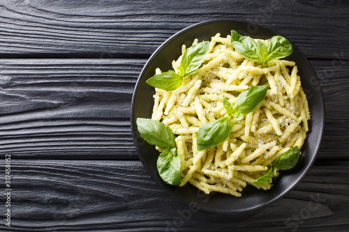 Fotografie Traditional trofie pasta with green basil pesto and parmesan cheese close-up in a plate