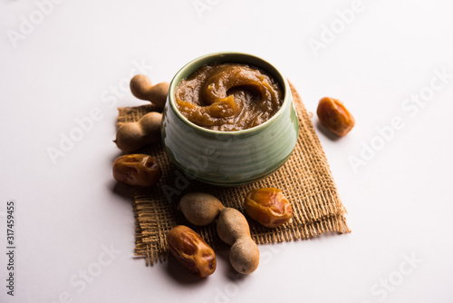 Dates Tamarind Chutney - Khajoor crushed to paste and mixed with Imli or imalee paste, served as a side dish in India photo