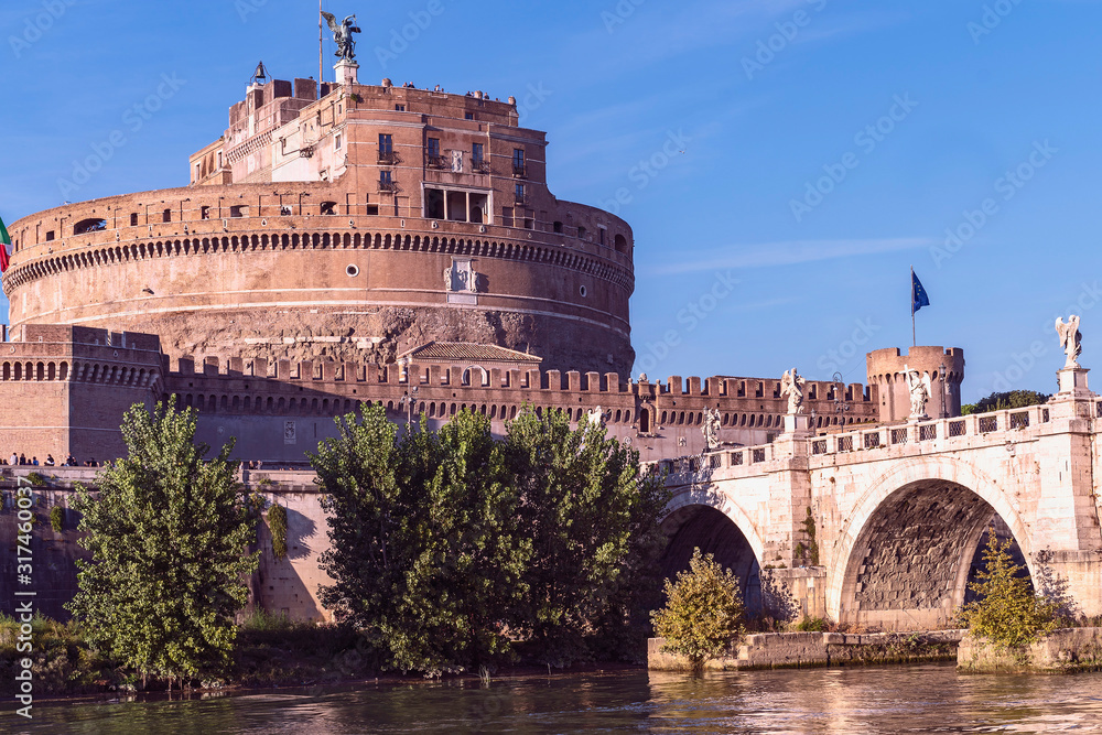 Rome, Italy - October 9, 2019 - view of the sculptures of angels and the castle of the Holy Angel on a background of blue sky