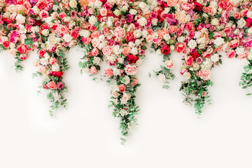 Flower pattern made of pink, beige roses flower buds on white background. Flat lay, top view.