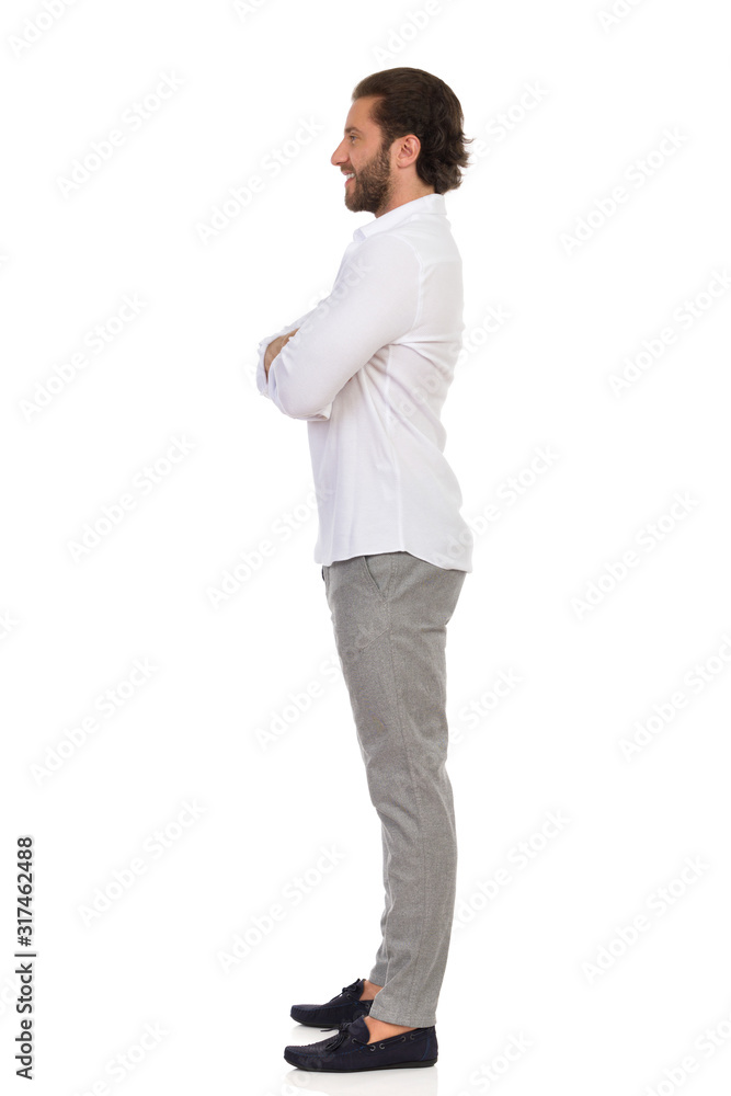 Handsome Man Is Standing With Arms Crossed And Looking Away. Side View.