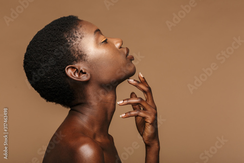 Beauty portrait of young half-naked african woman with short black hair photo