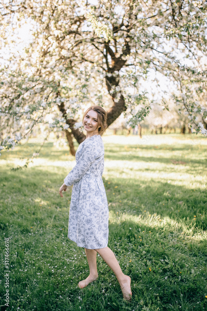 beautiful young brunette woman standing near the apple tree on a warm summer day beautiful young brunette woman standing near the apple tree on a warm summer day
