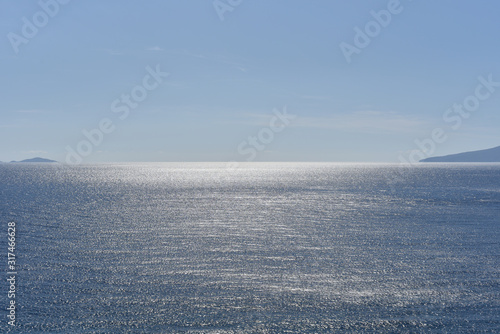 sea horizon with clear sky and sun reflection