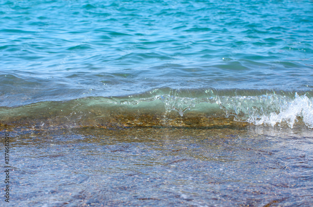 Soft wave of sea on sandy beach. Background.