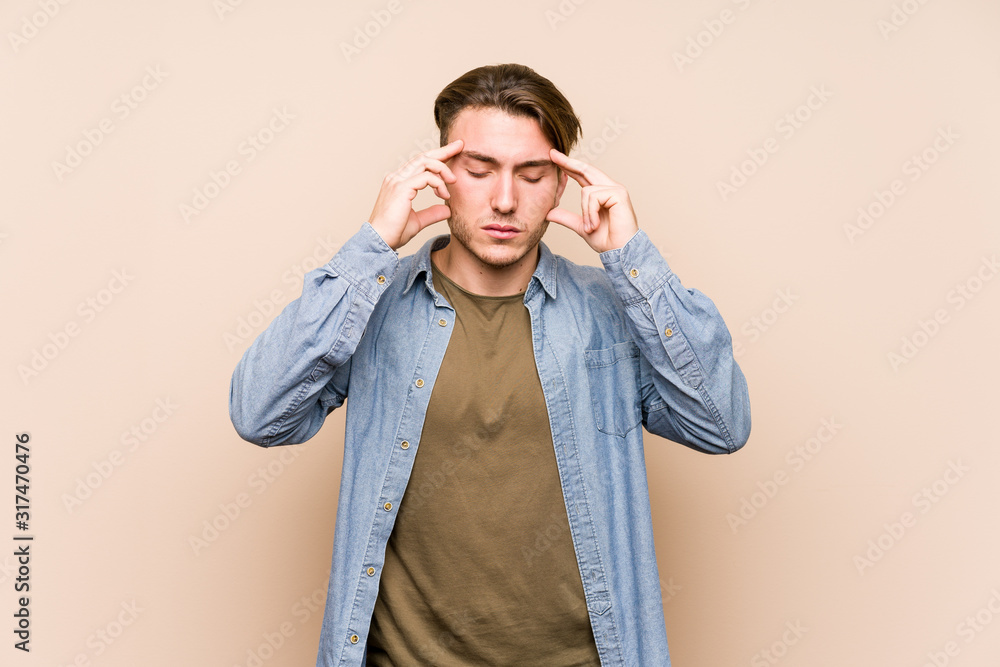 Young caucasian man posing isolated touching temples and having headache. Young caucasian man posing isolated touching temples and having headache.