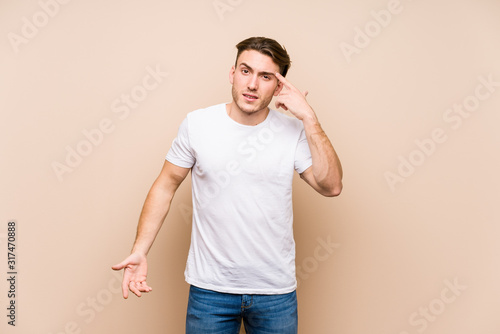 Young caucasian man posing isolated showing a disappointment gesture with forefinger.