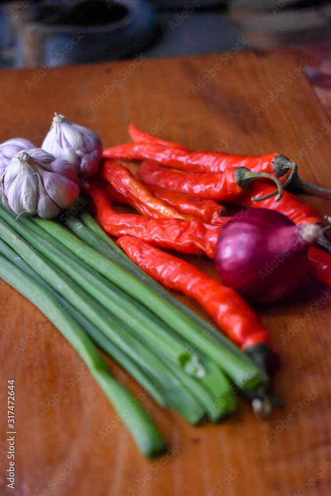 red hot chili peppers on wooden table red hot chili peppers on wooden table
