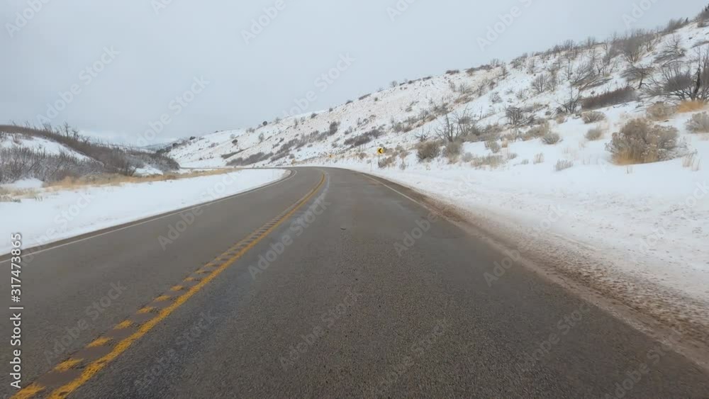 Winter snow blizzard driving rural mountain road POV. Winter storm in rural farming community. Mountain valley seasonal cold weather. Snow and ice on road and landscape. Driving point of view weather. Winter snow blizzard driving rural mountain road POV. Winter storm in rural farming community. Mountain valley seasonal cold weather. Snow and ice on road and landscape. Driving point of view weather.