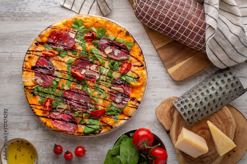 pizza with salami, cheese and balsamic vinegar alla bresaola