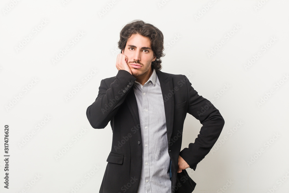 Young business man against a white background who is bored, fatigued and need a relax day. Young business man against a white background who is bored, fatigued and need a relax day.