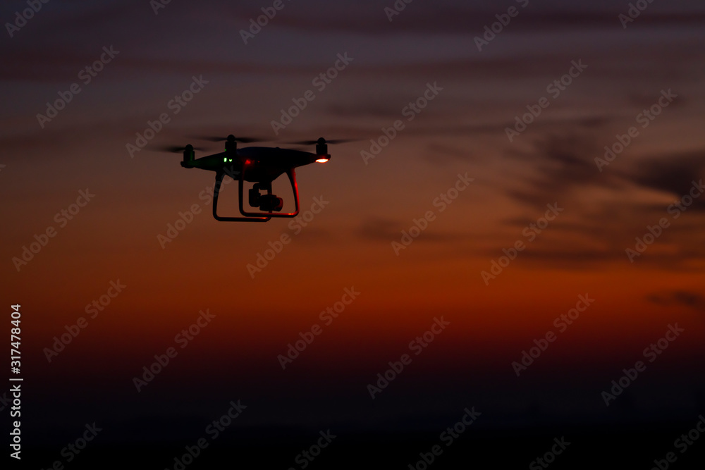 Drone in flight at sunset Drone in flight at sunset