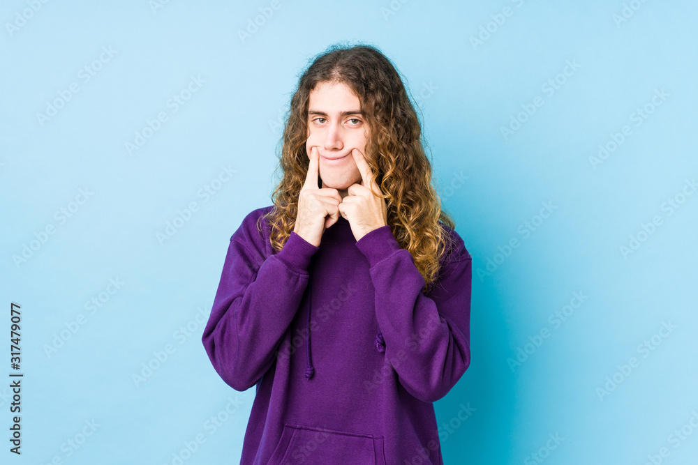 Long hair man posing isolated doubting between two options. Long hair man posing isolated doubting between two options.