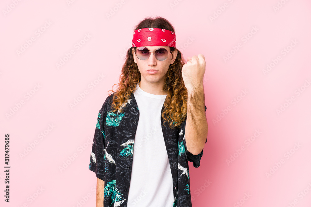 Young hippie caucasian man isolated showing fist to camera, aggressive facial expression. Young hippie caucasian man isolated showing fist to camera, aggressive facial expression.
