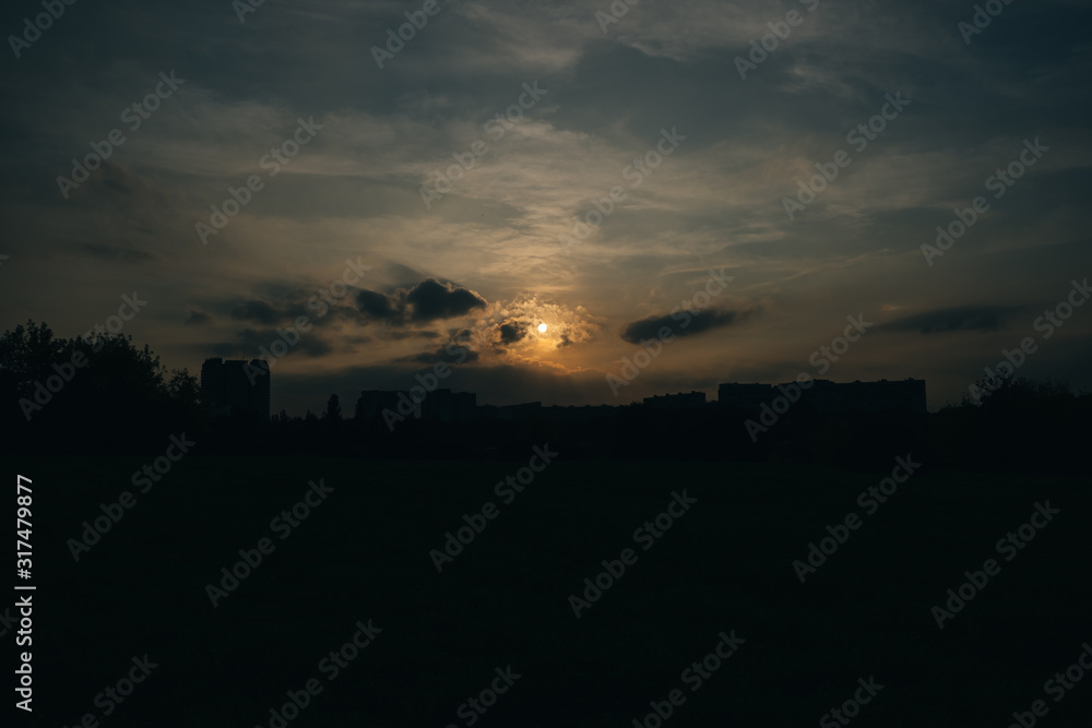 Beautiful dark sunset with clouds and sun Beautiful dark sunset with clouds and sun