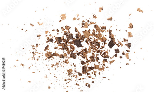 Chocolate shavings and chunks pile isolated on white background, top view