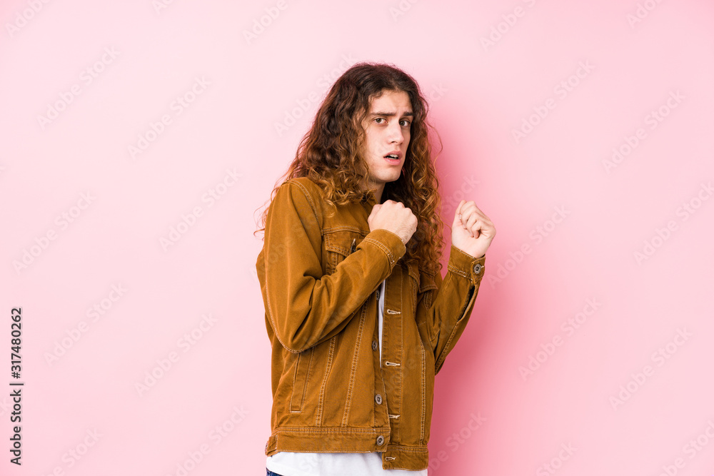 Young long hair man posing isolated scared and afraid. Young long hair man posing isolated scared and afraid.
